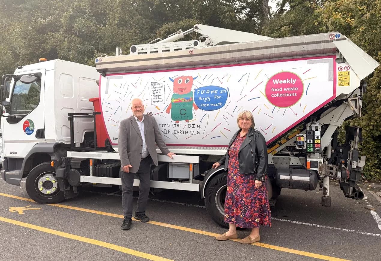 Cllr Laura James and Cllr Alan Oliver with a food waste truck 
